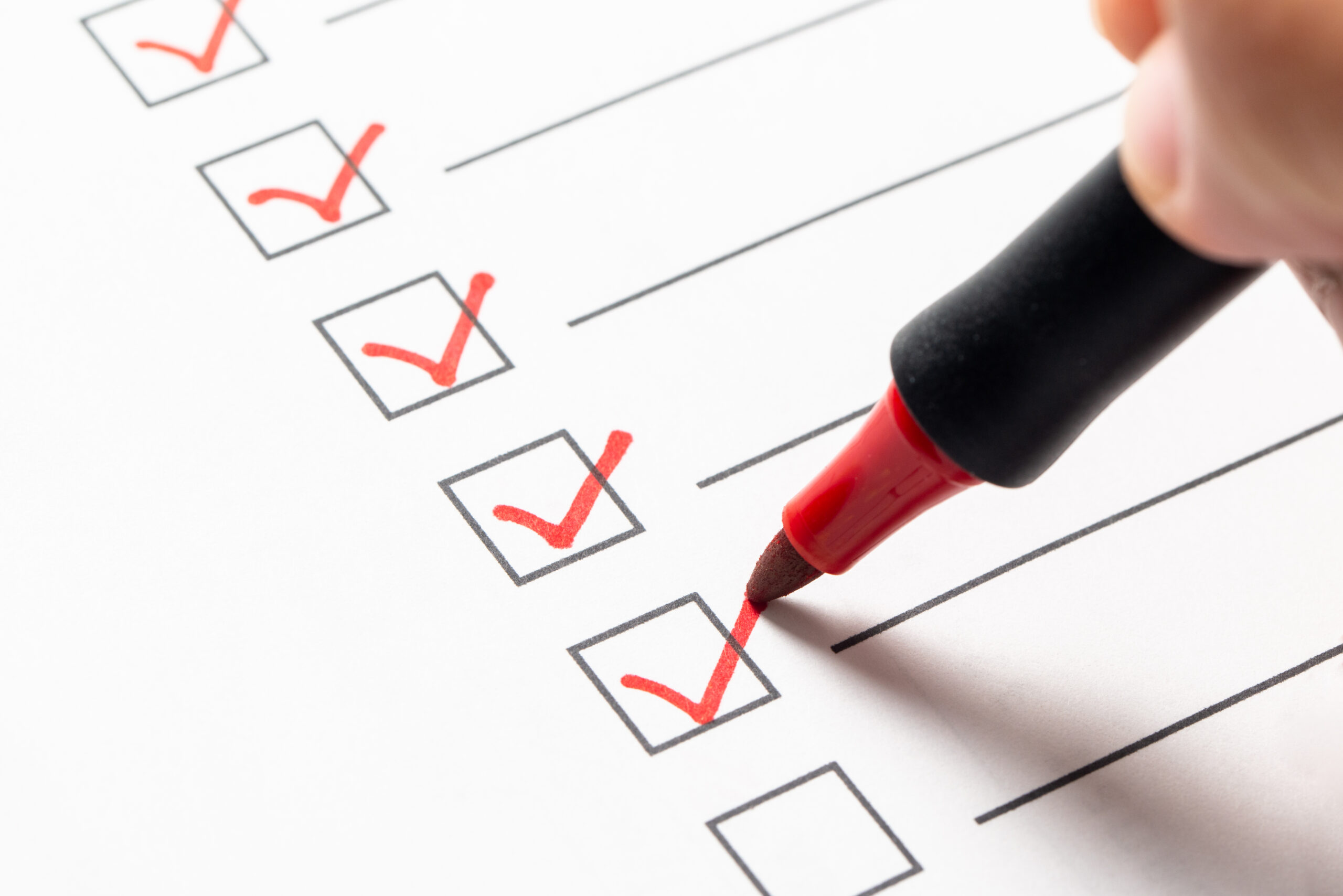 A medical malpractice case screening checklist with boxes checked off in red ink